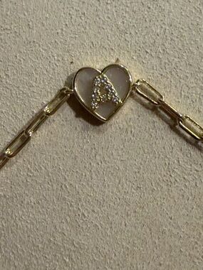 Initial “A” in CZ clear stones set in mother of pearl inmates in heart